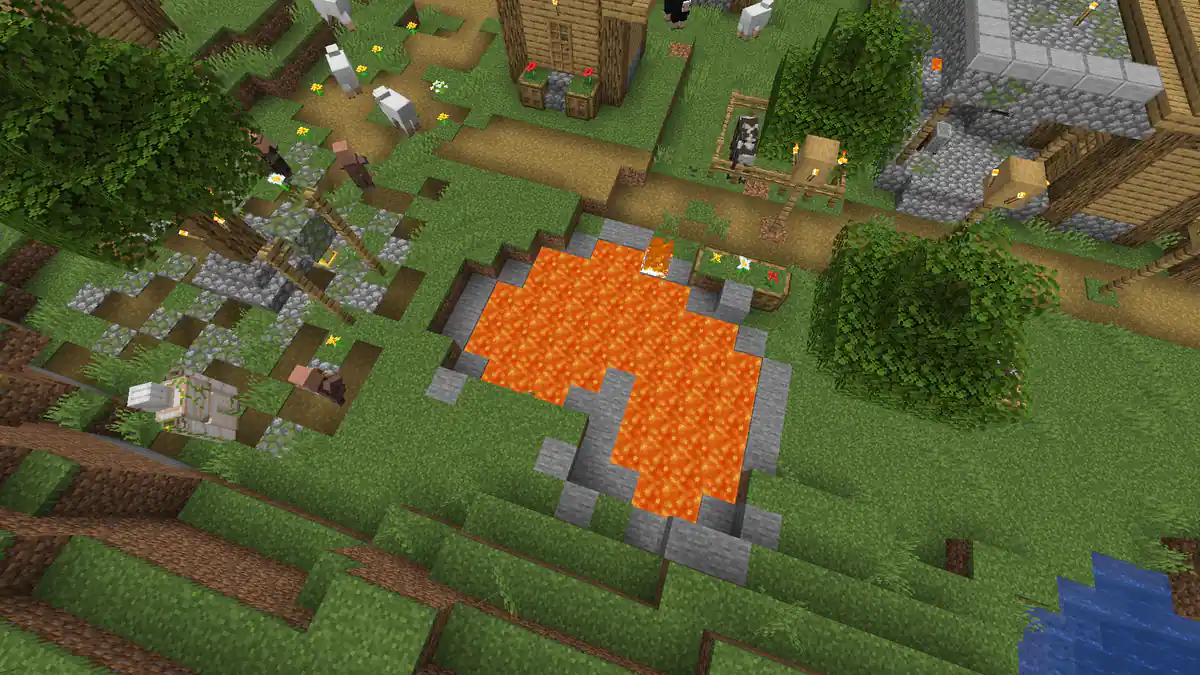 A village seen from above with a pool of lava in the middle of the grass between the houses, paths, trees and villagers walking past