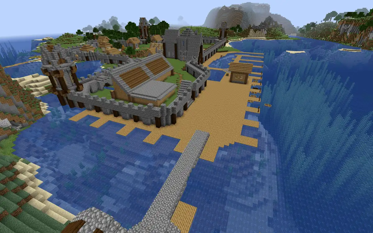 A walled harbour town beside the sea, with stone walls and towers, a large wooden hall, a church, houses and long wooden docks reaching out into the water