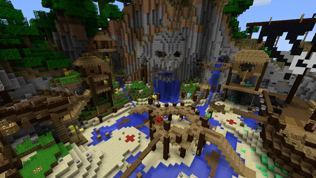 A pirate themed battle arena around a sandy cove, with a skull carved into a mountain, waterfalls, wooden walkways on posts, huts on stilts, a black and white flag and red crosses marked in the sand