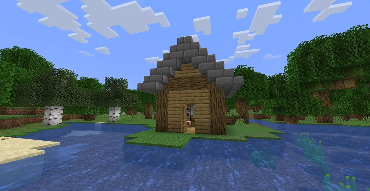 A small wooden starter house with a steep grey stone brick roof and an open door, on a little grass island in a shallow lake, with oak and birch trees and a sandy shore around it