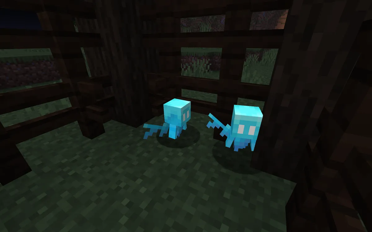 Two small blue allays with pale wings floating side by side on a mossy floor inside a cage of dark oak logs and fences